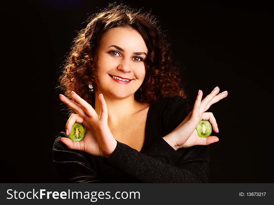 Portrait of a young woman with kiwi. Studio shot