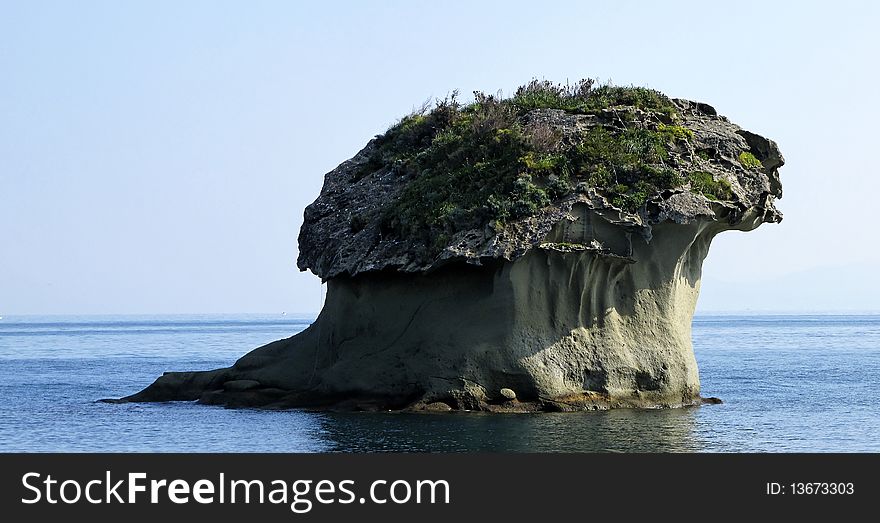 View of volcanic rock in the sea of ischia,in locality called lacco ameno