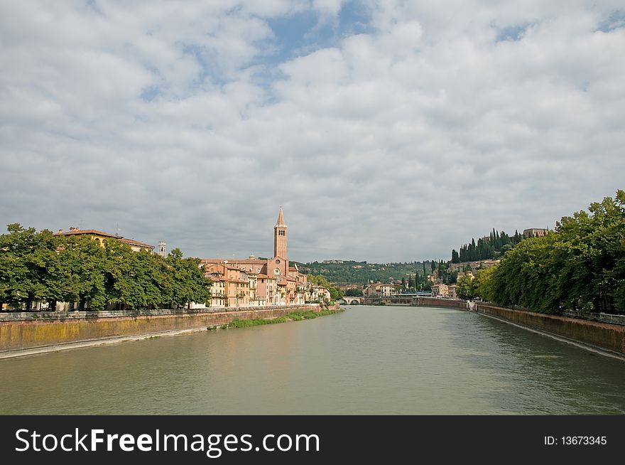 The river and view of basilica di sant anastasia from the bridge of ponte nuovo at verona in italy. The river and view of basilica di sant anastasia from the bridge of ponte nuovo at verona in italy