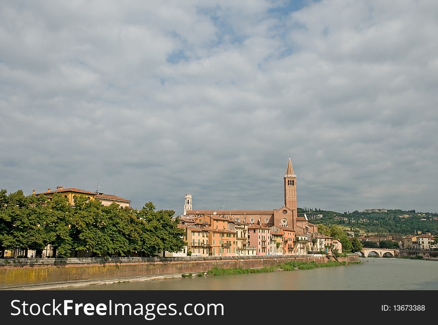 The river and view of basilica di sant anastasia from the bridge of ponte nuovo at verona in italy. The river and view of basilica di sant anastasia from the bridge of ponte nuovo at verona in italy