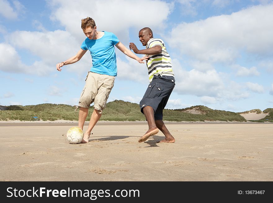 Two Young Men Palying Football On Beach The Together