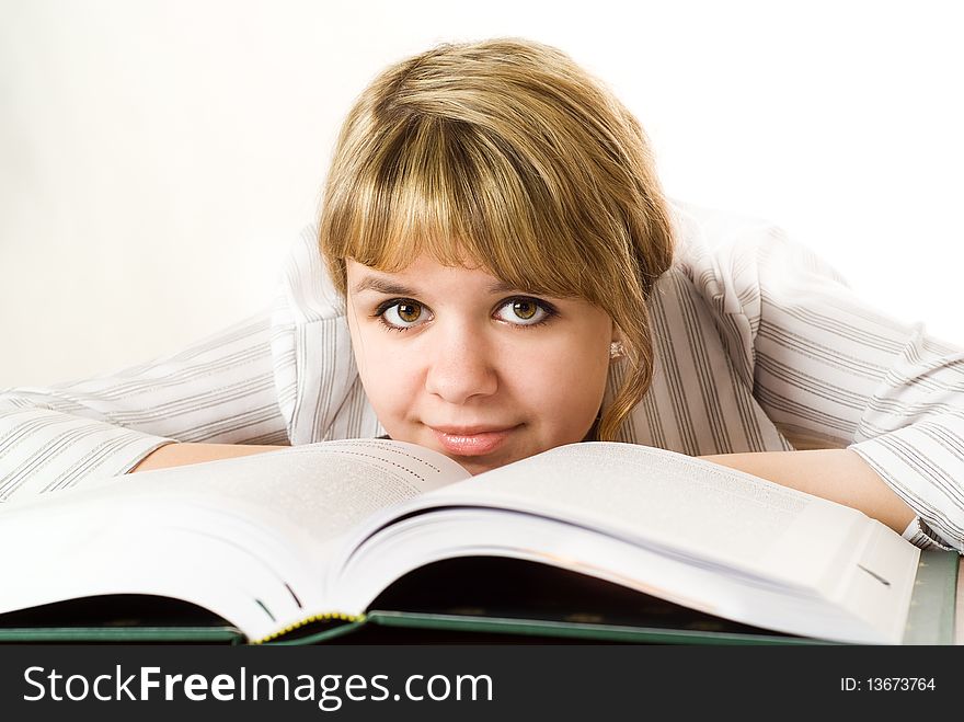 Young student with a book on white