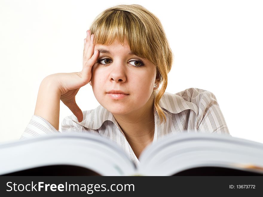 Beautiful young girl with a book on white