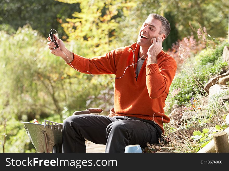 Man Outdoors Listening To MP3 Player