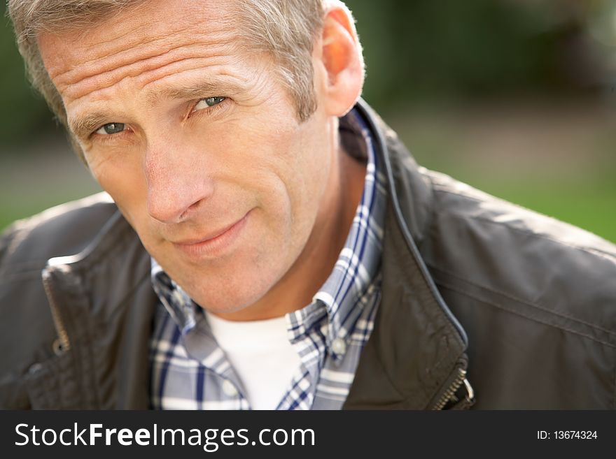 Close Up Portrait Of Man Standing Outside In Autumn Landscape