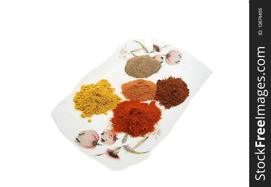 A white background with five different spices-black pepper,canella-paprika-clove-grill powder. A white background with five different spices-black pepper,canella-paprika-clove-grill powder