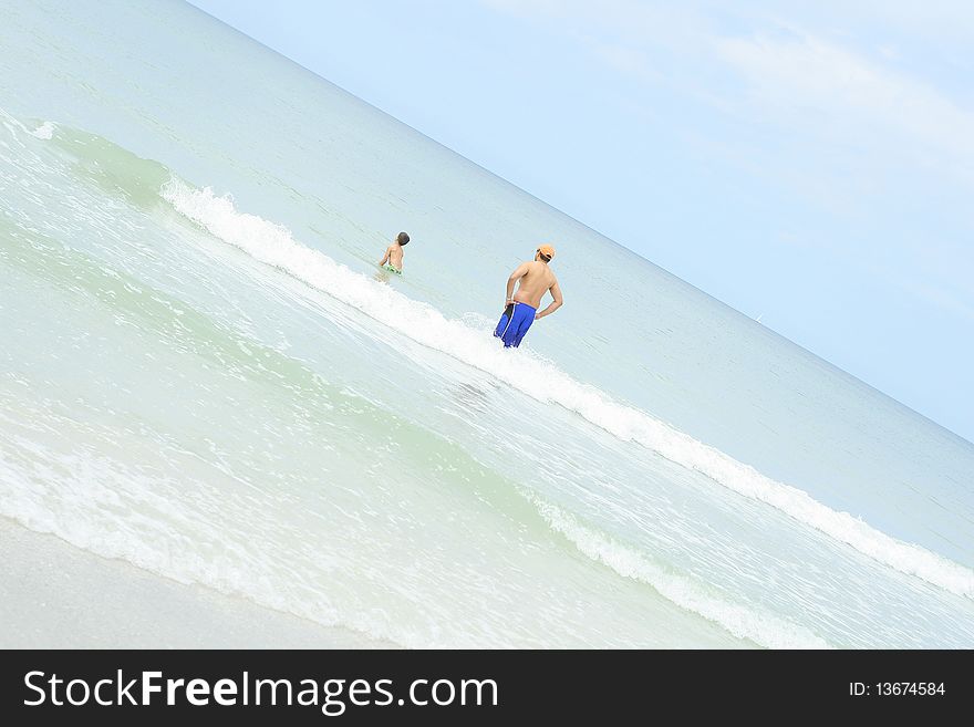 Shot of a father and son in the ocean angle