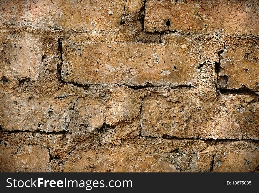 Close-up view of a rough textured cement brick wall. Close-up view of a rough textured cement brick wall