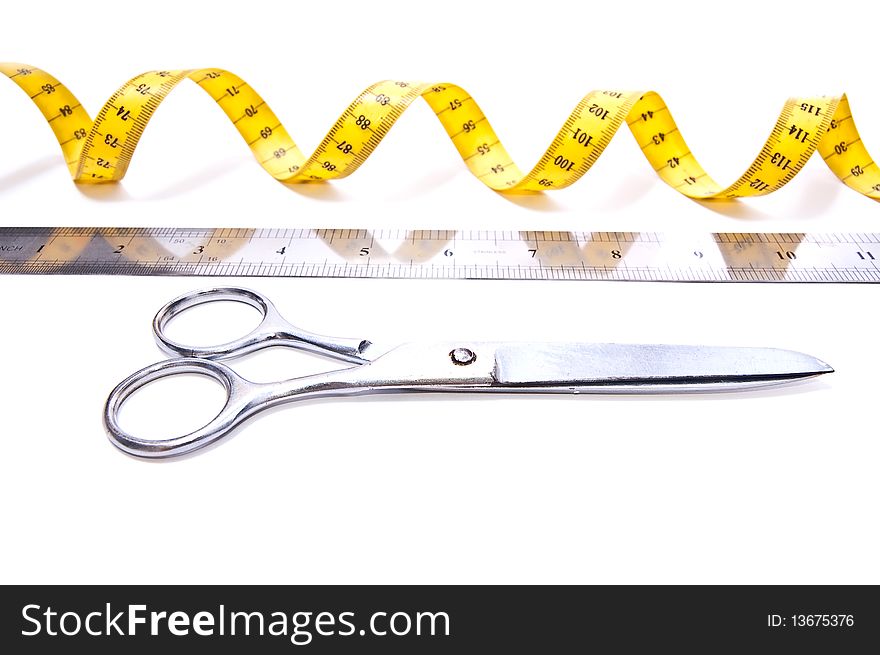 Yellow centimetre and steel scissors isolated on white. Yellow centimetre and steel scissors isolated on white