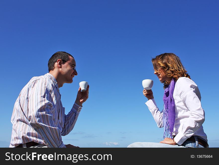 Young happy couple drinking coffee