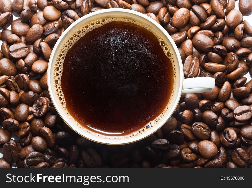 A cup of coffee with coffee  beans