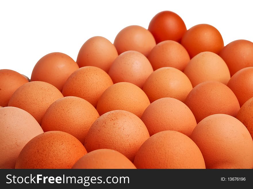 Brown eggs placed closely together isolated over white background. Brown eggs placed closely together isolated over white background.