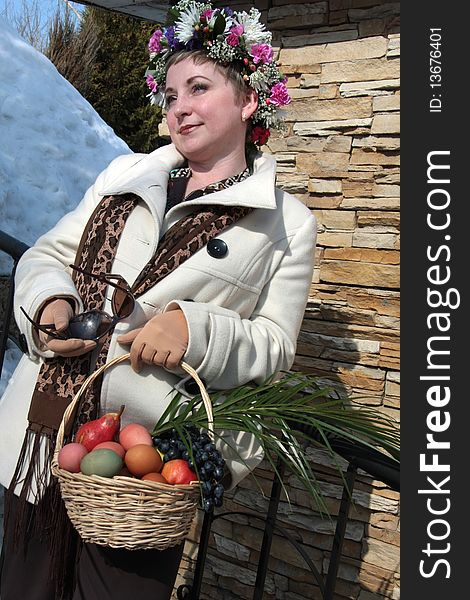 A girl wearing a crown with Easter basket