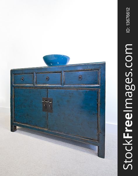 Beautiful vintage cupboard with three drawers and ceramic bowl on top