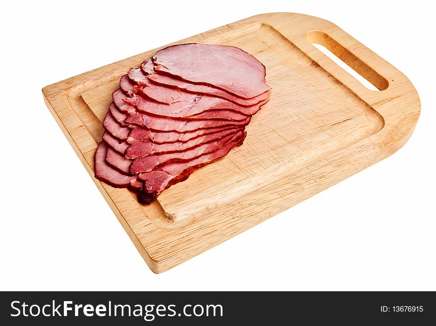 Smoked ham slices on wooden board isolated over white background. Smoked ham slices on wooden board isolated over white background.
