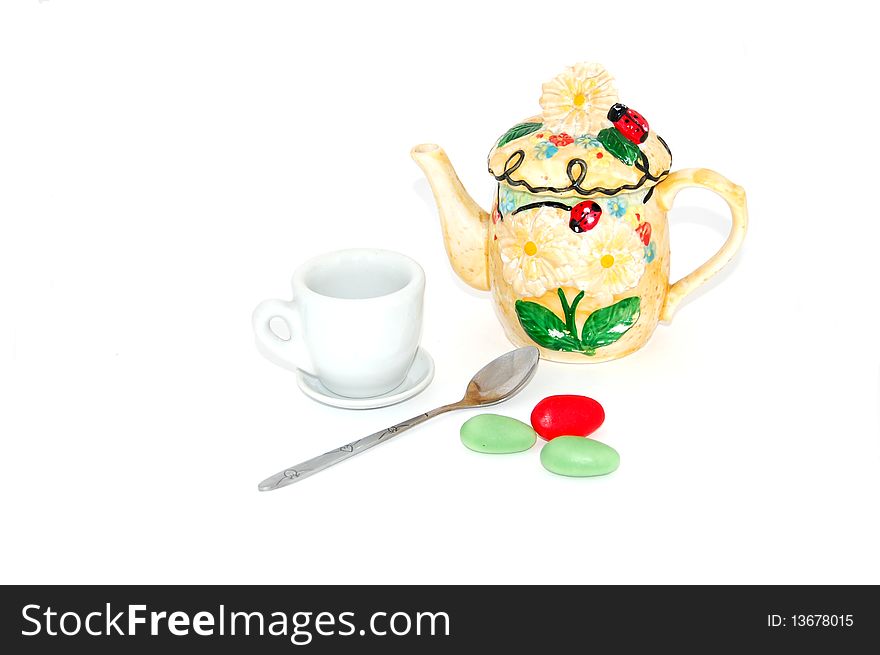 Tea pot,cup,spoon and candy isolated on white. Tea pot,cup,spoon and candy isolated on white.
