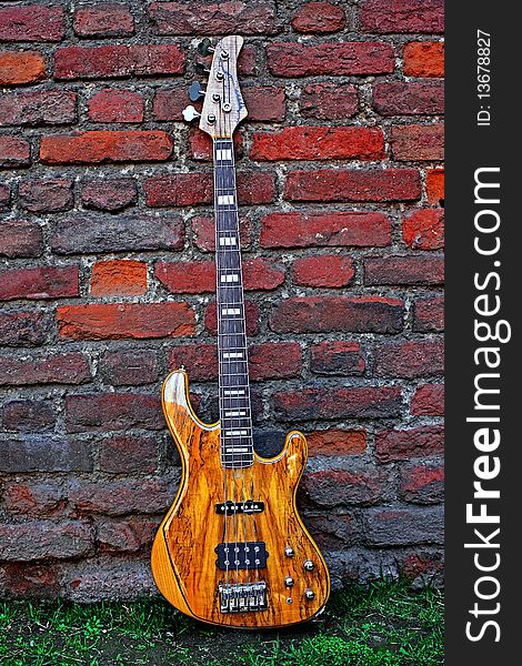 Electric Bass Guitar against a Brick Wall. Electric Bass Guitar against a Brick Wall