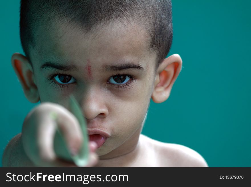 Indian cute boy posing to the camera with an expression