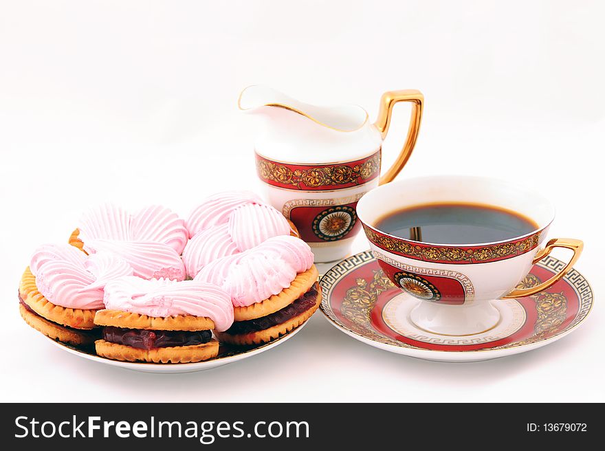 On a white background the image of a cup of coffee, cream and sweets. On a white background the image of a cup of coffee, cream and sweets