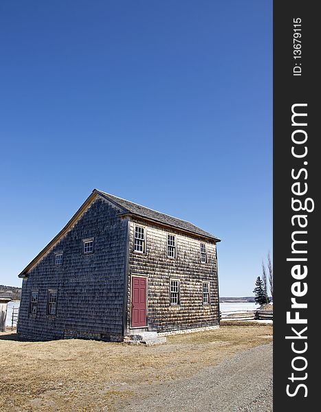 A cedar shake house on the bank of the St. John River in the historic settlement of Kings Landing, New Brunswick - Canada. A cedar shake house on the bank of the St. John River in the historic settlement of Kings Landing, New Brunswick - Canada