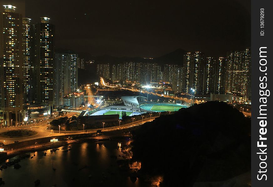 A night view with a outdoor sport centre, nearby a bay. A night view with a outdoor sport centre, nearby a bay
