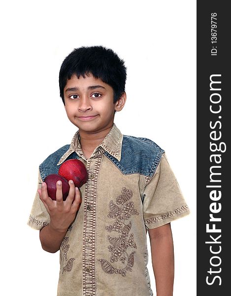 An handsome Indian klid holding apples to eat. An handsome Indian klid holding apples to eat