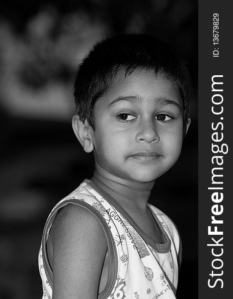 An handsome indian kid looking very thoughtful