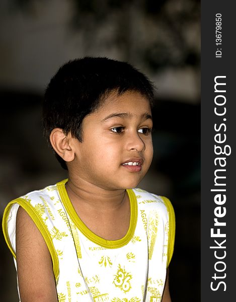 An handsome indian kid looking very thoughtful