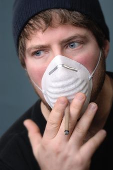 Man Smoking Cigarette With Face Mask Royalty Free Stock Images