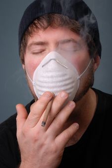 Man Smoking Cigarette With Face Mask Stock Images