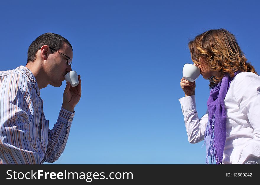 Young happy couple drinking coffee