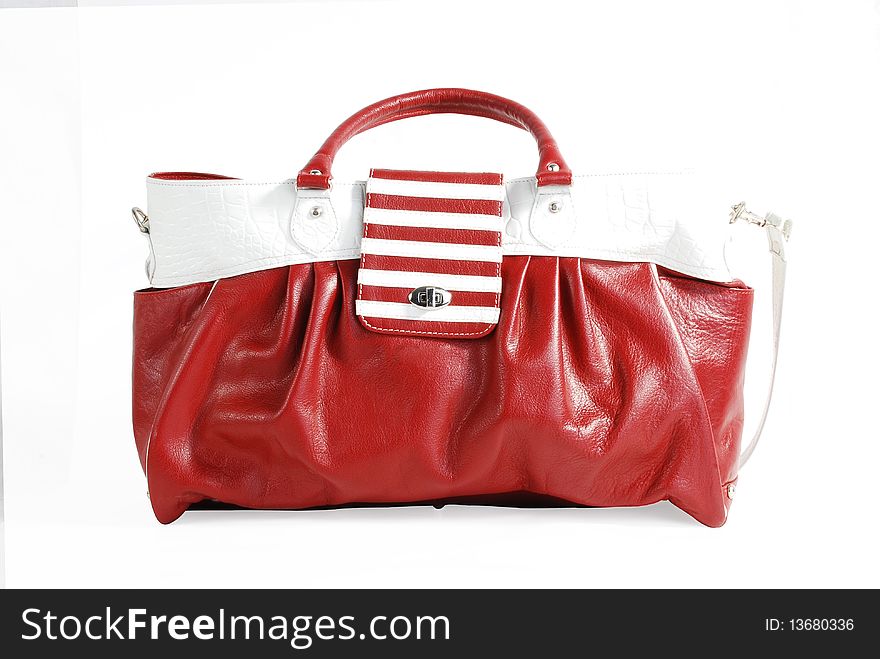 This is beautiful red and white leather ladies handbag isolated on a white background. This is beautiful red and white leather ladies handbag isolated on a white background.