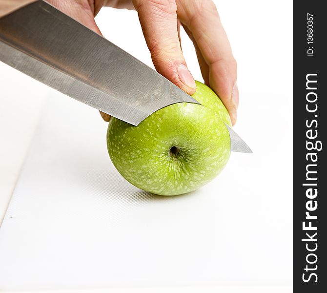 Sliced green apple in multiple peices with knife. Sliced green apple in multiple peices with knife