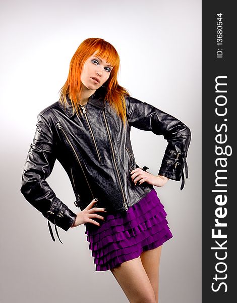 Fashionable dancing girl in a leather jacket