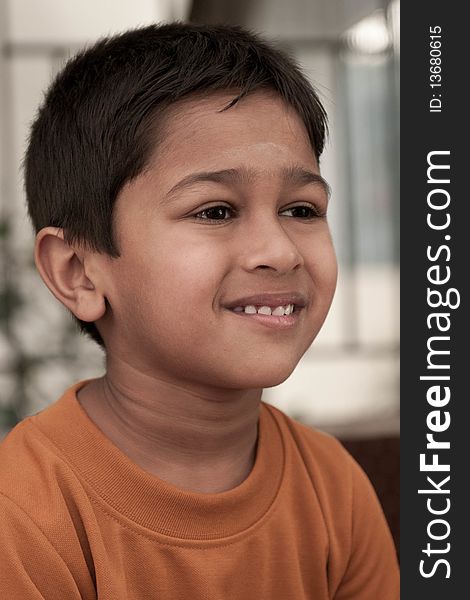 Handsome Indian kid smirking in front of the camera