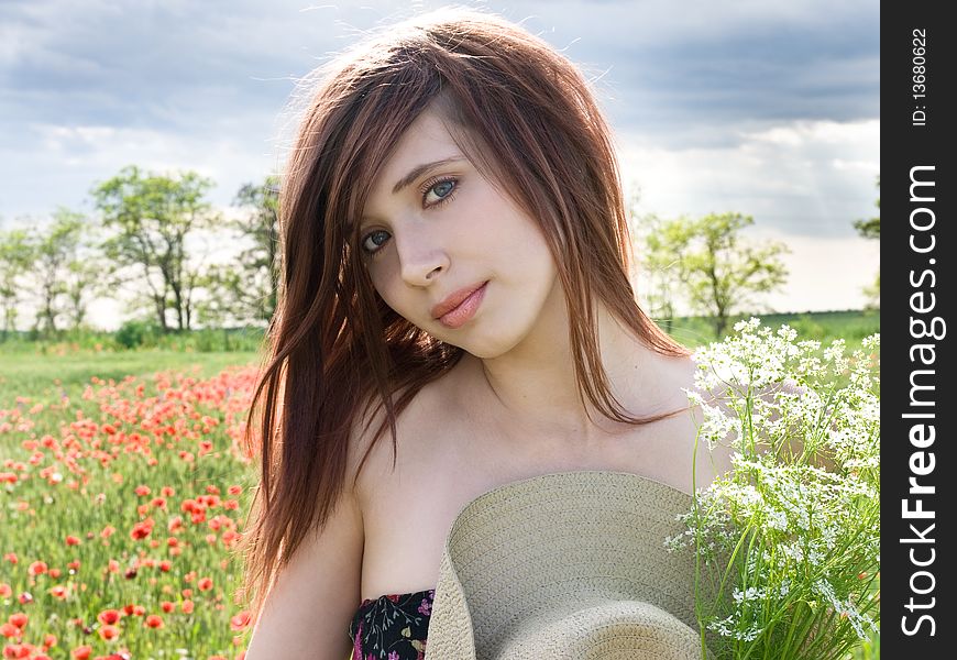 Beautiful young girl in summer field