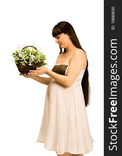 A pregnant woman holding a basket of lilies of the valley. A pregnant woman holding a basket of lilies of the valley