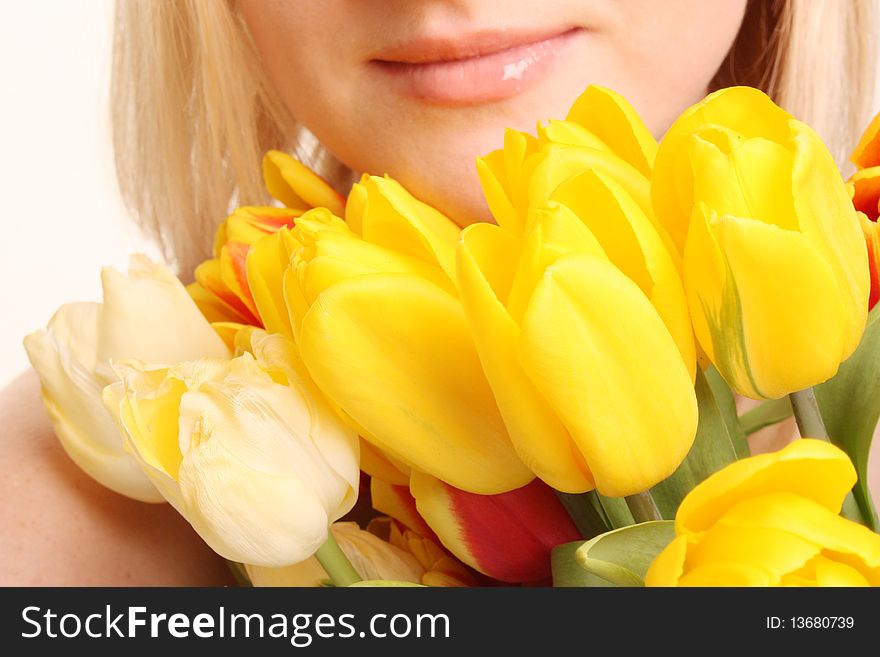 The beautiful woman with bouquet of yellow tulips. The beautiful woman with bouquet of yellow tulips