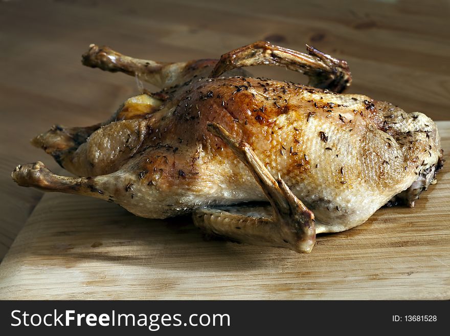 Roasted duck on wooden table