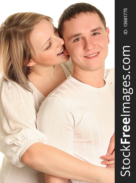 Beautiful young couple kissing isolated over white background. Beautiful young couple kissing isolated over white background