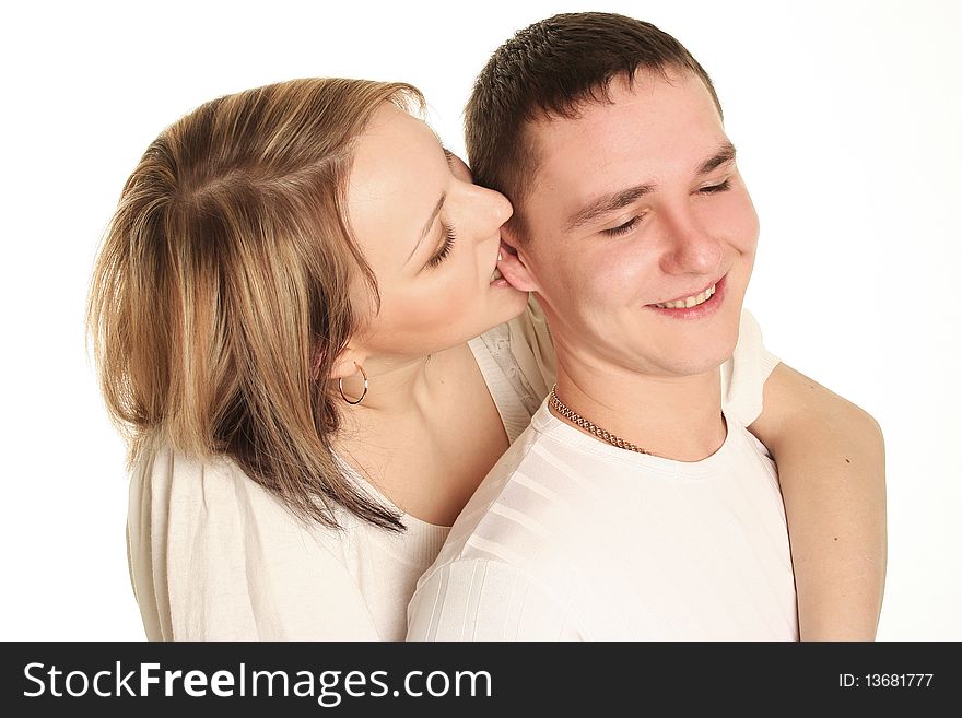 Beautiful young  couple kissing isolated over white background. Beautiful young  couple kissing isolated over white background