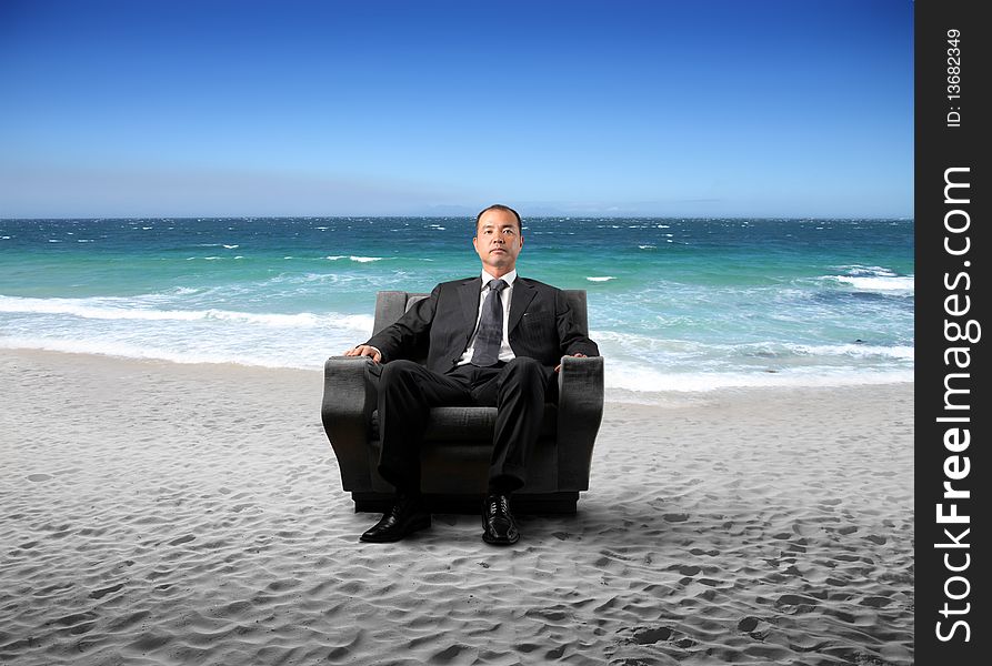 Japanese businessman sitting on an armchair at the seaside. Japanese businessman sitting on an armchair at the seaside