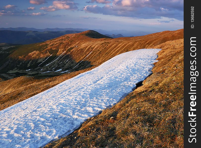 Spring in mountains and last snow. The Ukrainian mountains Carpathians