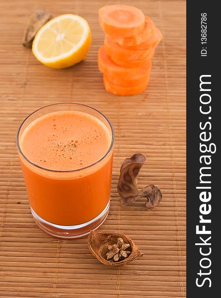 Fresh carrot juice and fruit with dried herbs