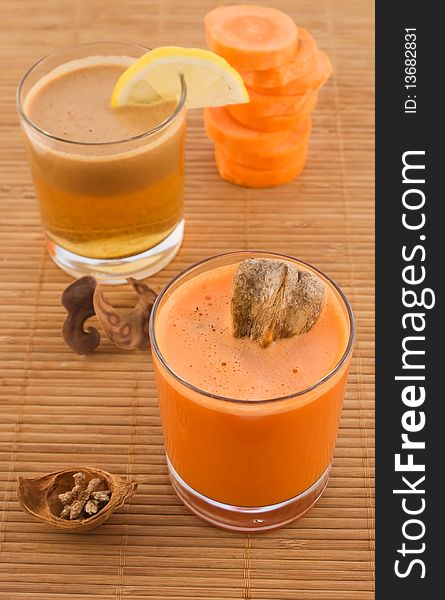 Fresh carrot juice and fruit with dried herbs