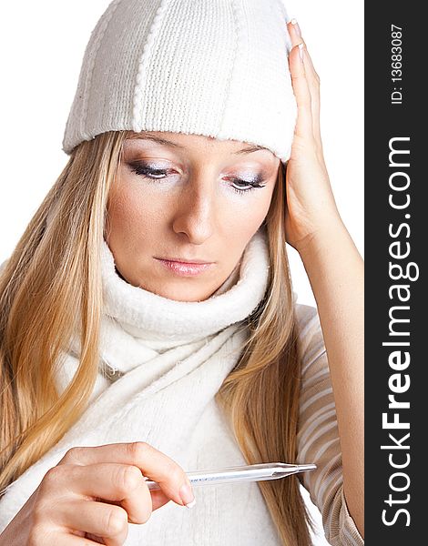 Caucasian blonde woman holding thermometer with white hat and scarf. Caucasian blonde woman holding thermometer with white hat and scarf