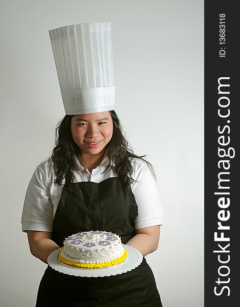 Baker presenting a (birthday cake) to the viewer. Useful for parties and celebrations. Baker presenting a (birthday cake) to the viewer. Useful for parties and celebrations.