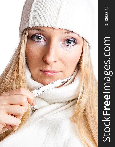 Caucasian blonde woman holding thermometer with white hat and scarf. Caucasian blonde woman holding thermometer with white hat and scarf