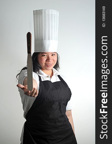 Chef delicately balancing her knife. Chef delicately balancing her knife