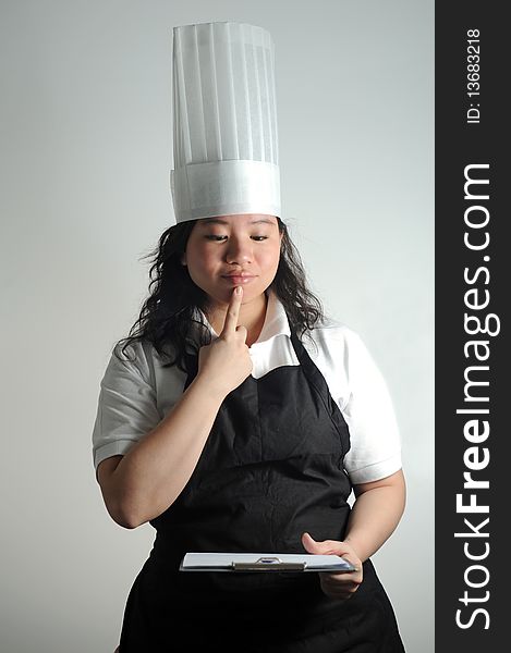 Chef pondering over cooking checklist